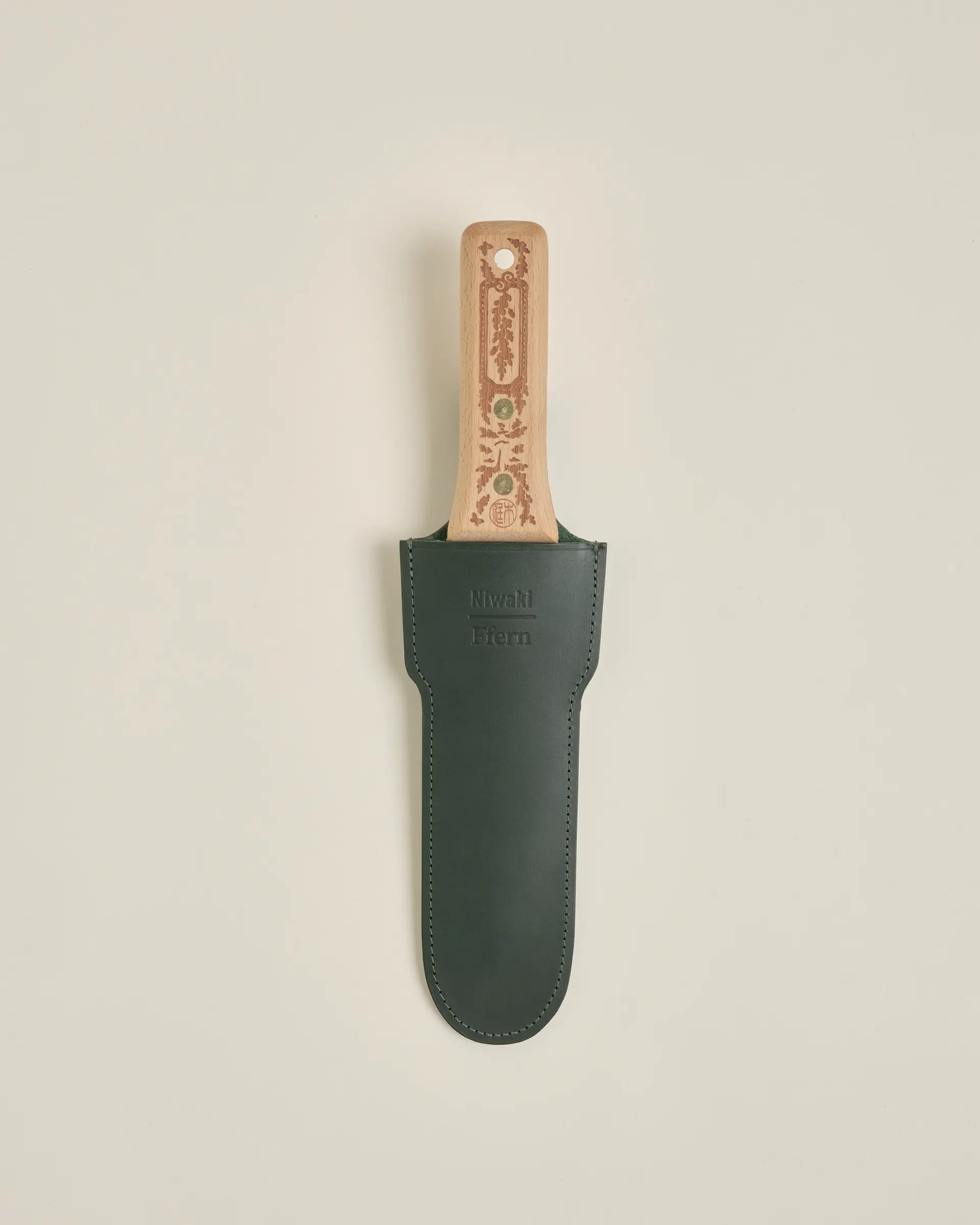 Knife in emerald leather sheath